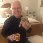 Greg Freels with gold retriever puppy